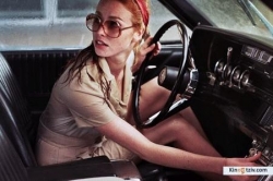 La dame dans l'auto avec des lunettes et un fusil 2015 photo.